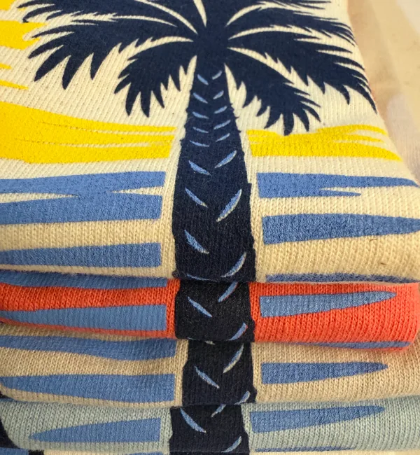 Close-up showing print detail and how the colors look on different shirts.